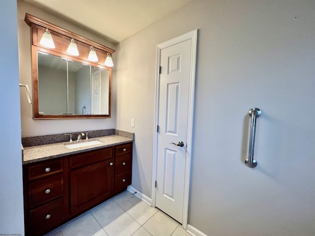 bathroom featuring tile patterned flooring, vanity, and baseboards