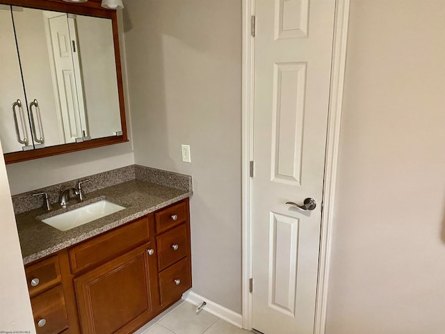 bathroom featuring tile patterned flooring and vanity