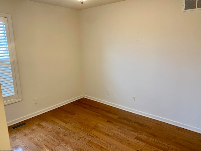 spare room with wood-type flooring