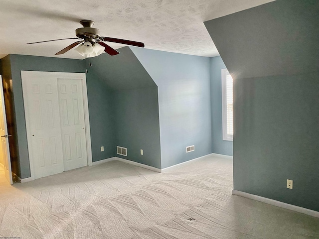 bonus room with visible vents, ceiling fan, and light colored carpet
