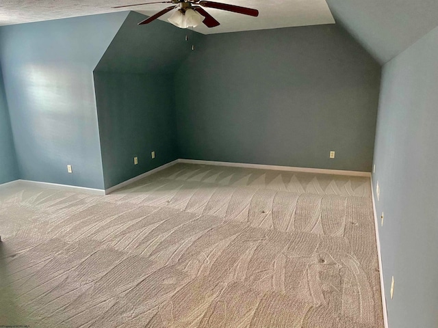 additional living space with ceiling fan, a textured ceiling, lofted ceiling, and carpet flooring