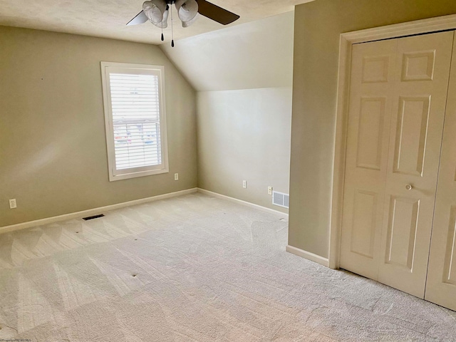 bonus room with vaulted ceiling, ceiling fan, and light carpet