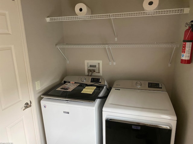 laundry area with independent washer and dryer