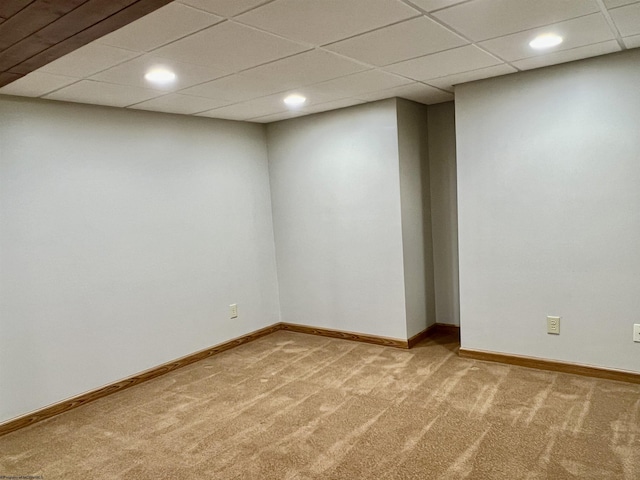 finished below grade area with baseboards, recessed lighting, carpet, and a drop ceiling