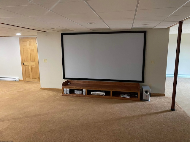 cinema with baseboard heating, a paneled ceiling, and carpet flooring