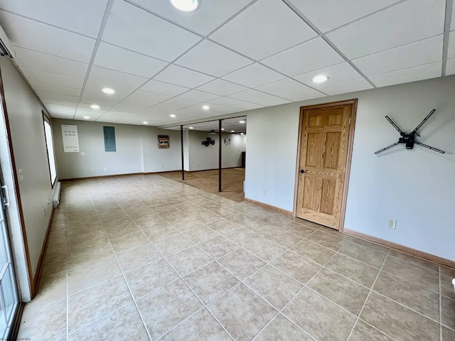 finished below grade area featuring recessed lighting, light tile patterned flooring, and a drop ceiling