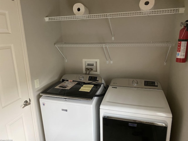 laundry room featuring separate washer and dryer and laundry area