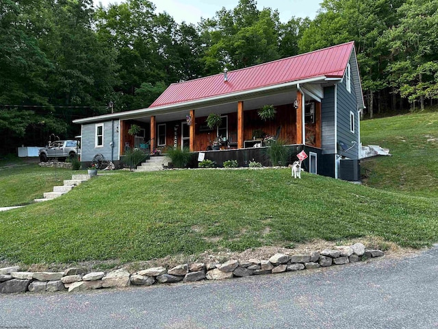 view of front of home featuring central AC unit, a front lawn, and a porch