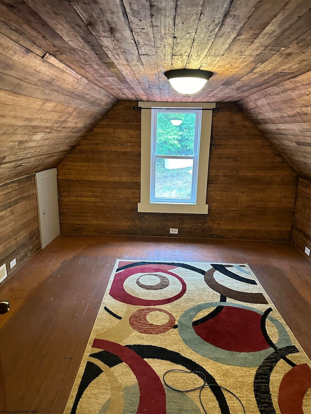 bonus room with vaulted ceiling, wood walls, wooden ceiling, and dark wood-type flooring