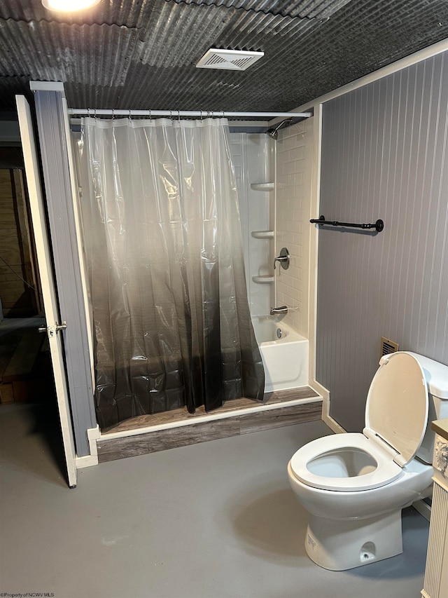 bathroom with shower / bathtub combination with curtain, concrete floors, and toilet