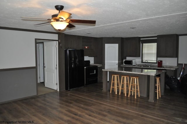 227 Joe Kincaid Rd, Fairmont, WV 26554 - kitchen with black appliances, a sink, a kitchen breakfast bar, ceiling fan, and dark wood-style flooring