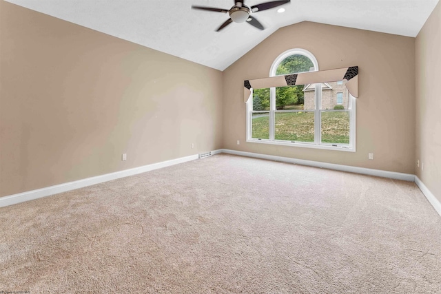 spare room with ceiling fan, lofted ceiling, and carpet flooring