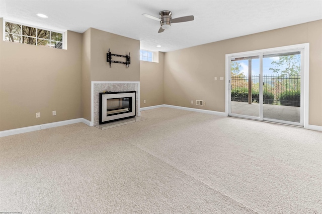 unfurnished living room with ceiling fan and light colored carpet