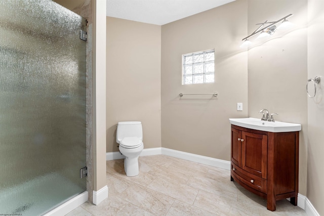 bathroom featuring tile patterned flooring, a shower with door, vanity, and toilet