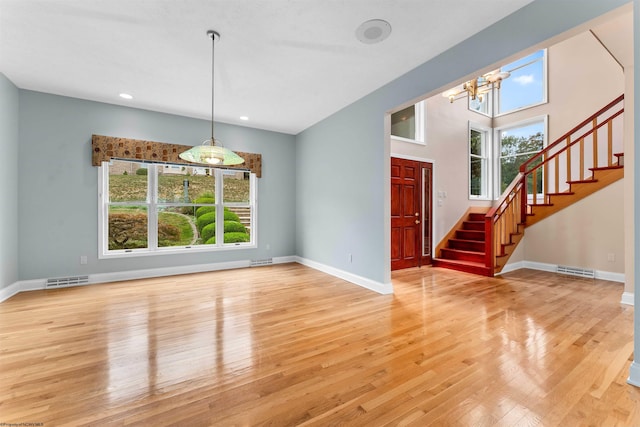 interior space with light wood-type flooring and a chandelier