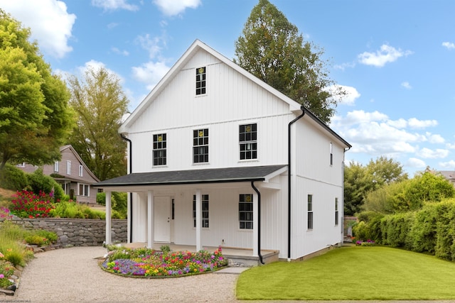 modern inspired farmhouse featuring a porch and a front lawn