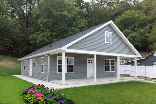 view of front of home with a porch and a front yard