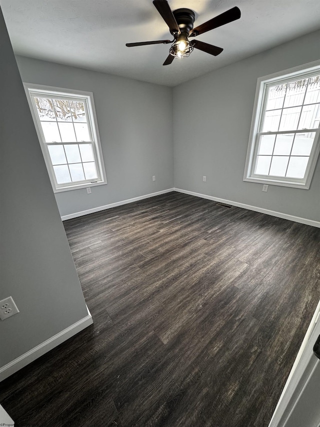 spare room with ceiling fan and dark hardwood / wood-style floors