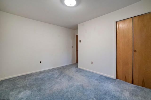 unfurnished bedroom with a closet and carpet floors