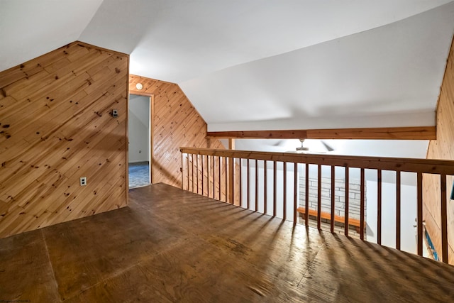 bonus room featuring wooden walls and lofted ceiling