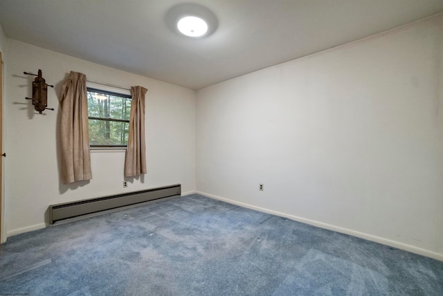 carpeted empty room featuring a baseboard heating unit