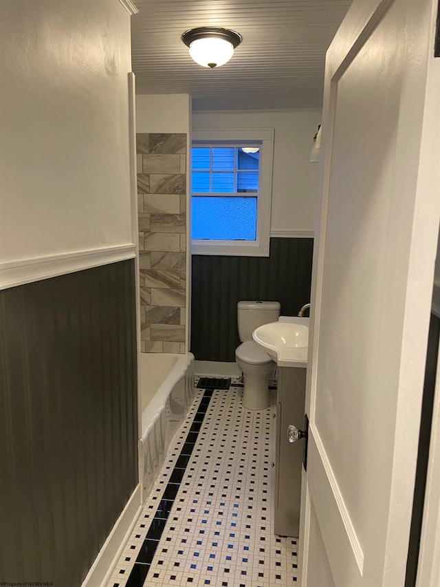 full bathroom with tile patterned floors, washtub / shower combination, vanity, and toilet