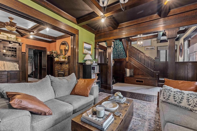 living room featuring wooden walls, beam ceiling, and ceiling fan