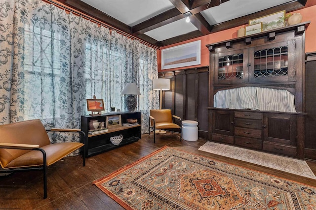 living area featuring coffered ceiling, beam ceiling, and dark wood-type flooring