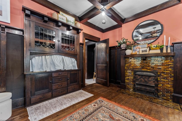 bedroom featuring beam ceiling, coffered ceiling, and dark hardwood / wood-style flooring