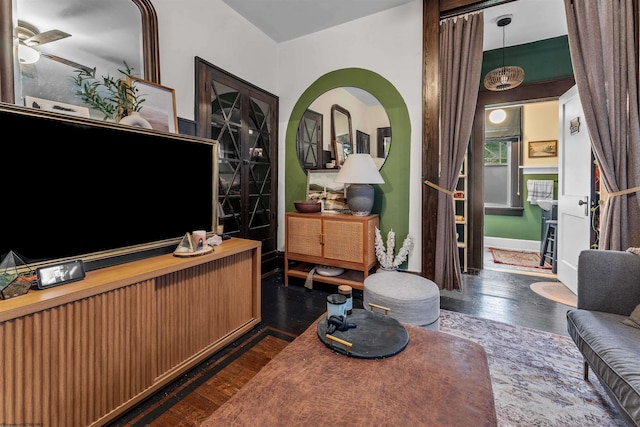 living room with ceiling fan and dark hardwood / wood-style floors