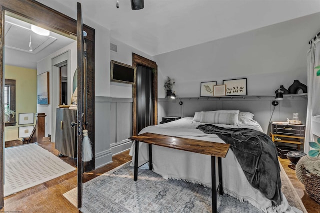 bedroom with ceiling fan and hardwood / wood-style floors