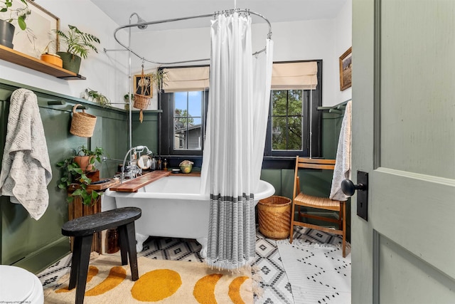 bathroom featuring shower with separate bathtub, plenty of natural light, and toilet