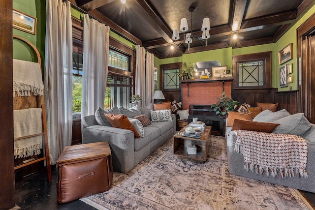 living room with coffered ceiling, beam ceiling, wood walls, and a brick fireplace