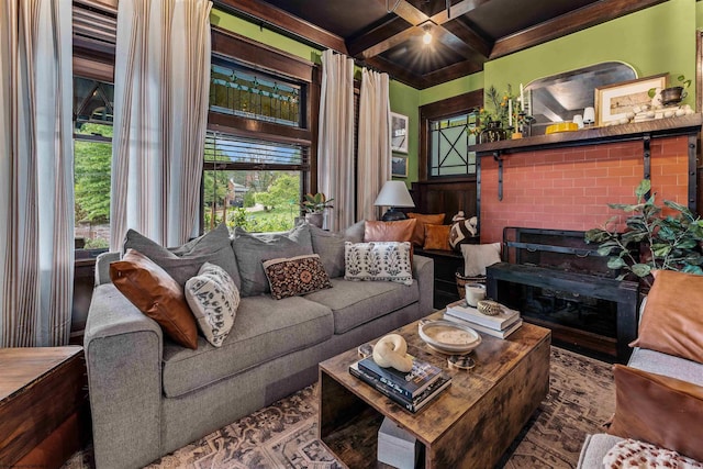 living room featuring beam ceiling, coffered ceiling, and a fireplace