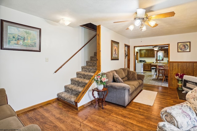 living room with heating unit, ceiling fan, and hardwood / wood-style flooring