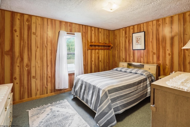 carpeted bedroom with wooden walls and a textured ceiling