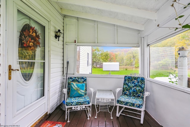 sunroom / solarium with vaulted ceiling with beams