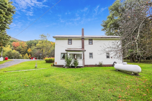 rear view of house with a lawn