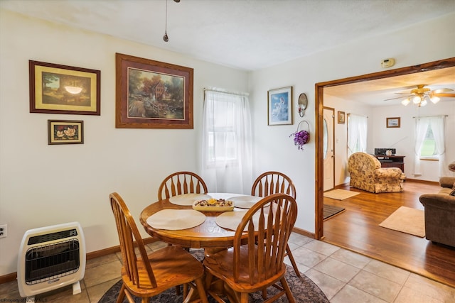 dining space with ceiling fan, heating unit, and light hardwood / wood-style flooring