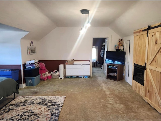 interior space with lofted ceiling and a barn door