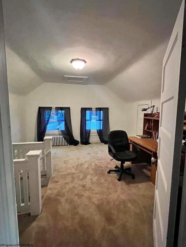 home office with carpet floors, a textured ceiling, and lofted ceiling