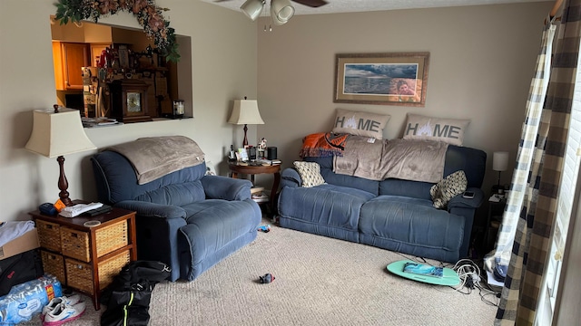 carpeted living room featuring ceiling fan