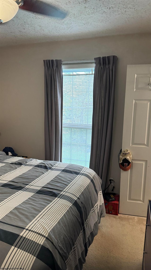 carpeted bedroom featuring a textured ceiling