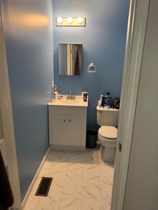 bathroom with baseboards, visible vents, toilet, marble finish floor, and vanity