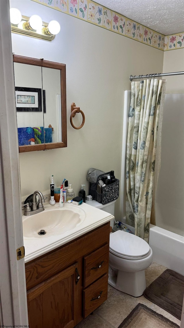 bathroom featuring a textured ceiling, toilet, vanity, tile patterned floors, and shower / bath combination with curtain