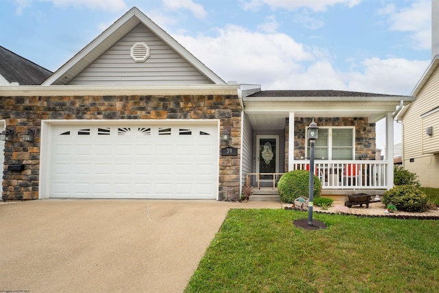 view of front of home with a garage, a front lawn, and a porch