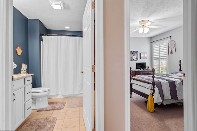 bathroom featuring vanity, tile patterned flooring, a shower with shower curtain, ceiling fan, and toilet