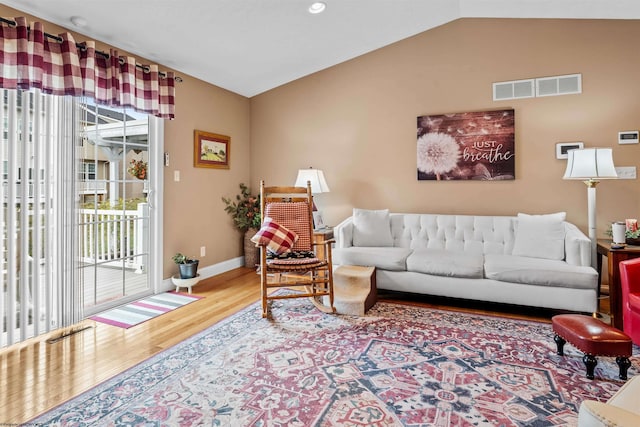 living room with lofted ceiling and hardwood / wood-style floors