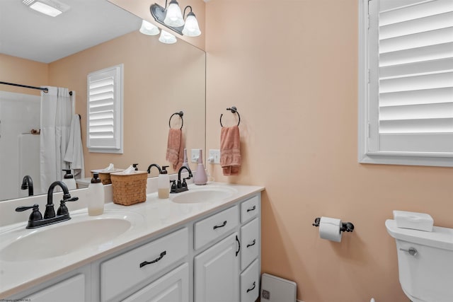 bathroom featuring walk in shower, vanity, and toilet