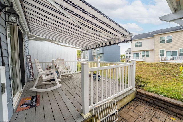 wooden deck featuring a lawn